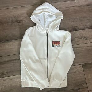 Cream colored Rip Curl kids zip up jacket with goodie and pockets